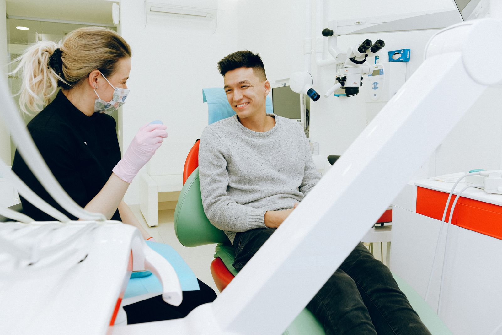 A dentist and patient smiling during a check-up