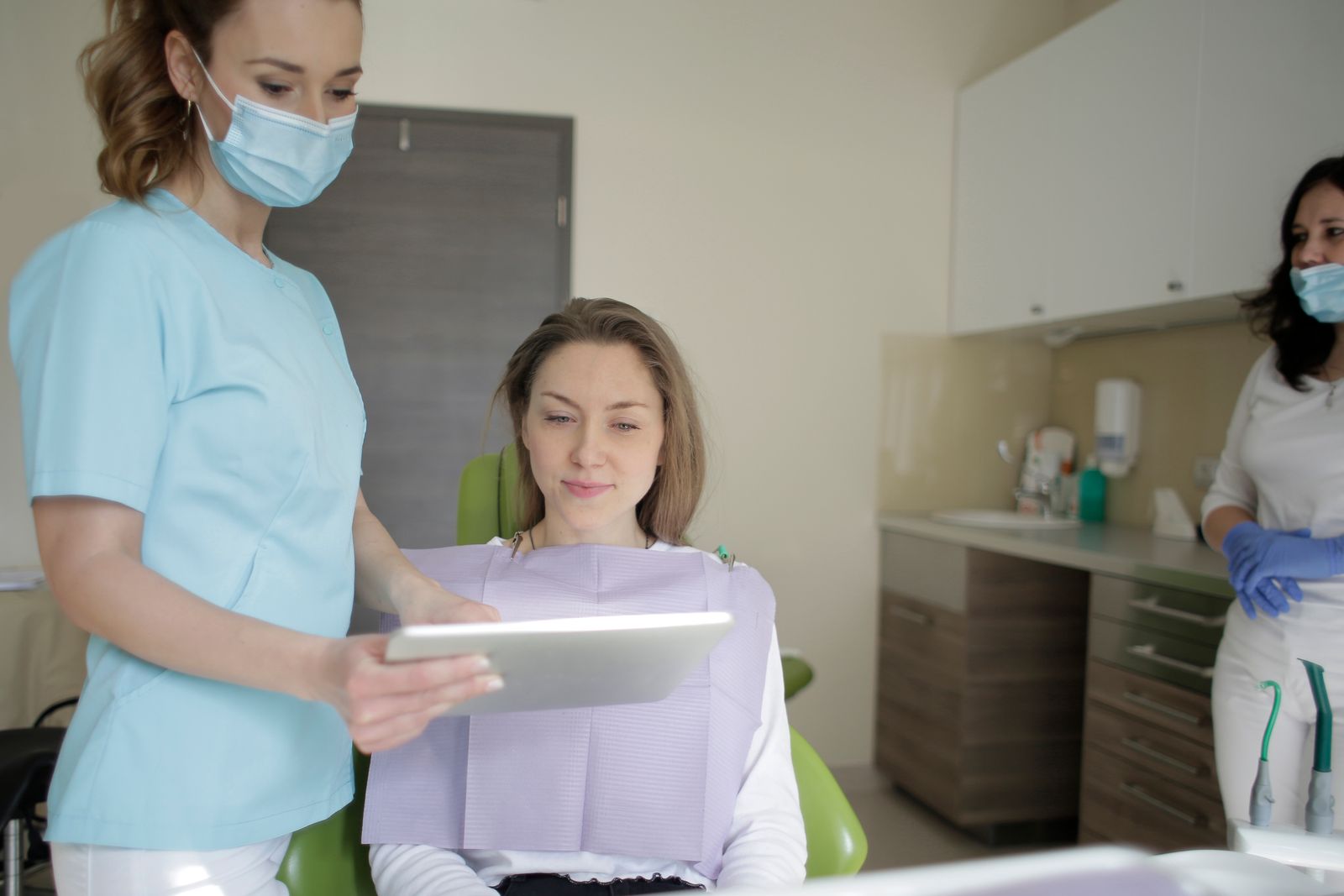 A dentist showing a patient their treatment plan